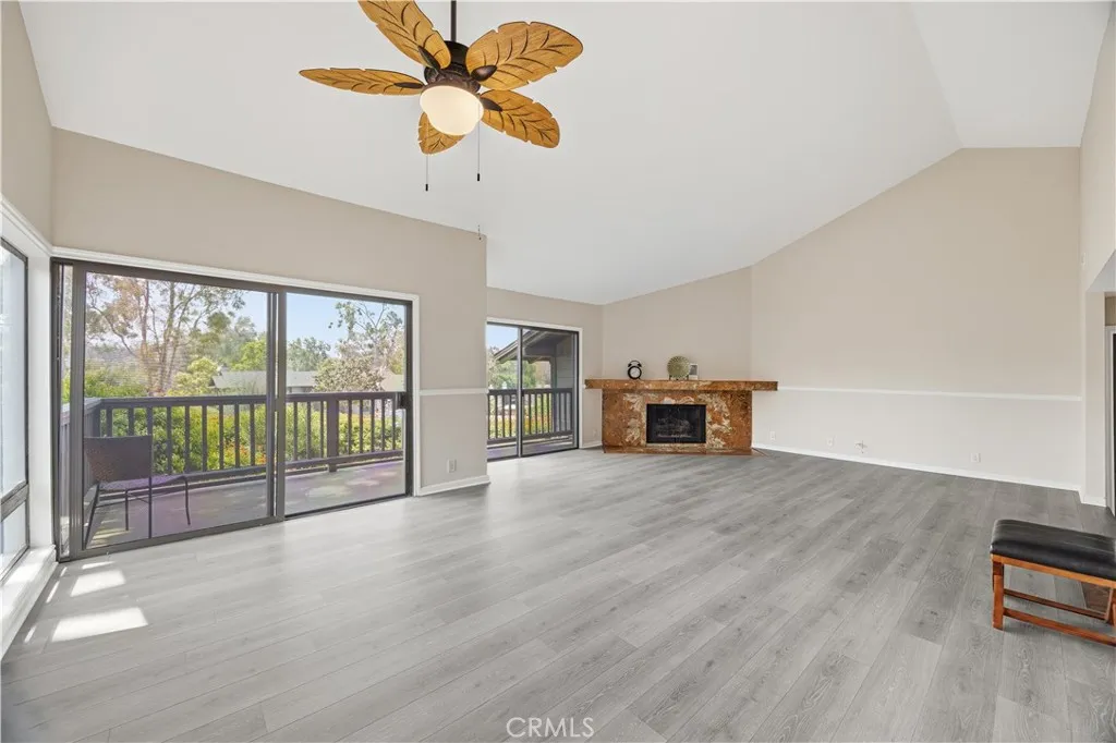 Another view of the dining room, living room with brand-new ceiling fan/light for the dining room. Brand-new luxury floor.