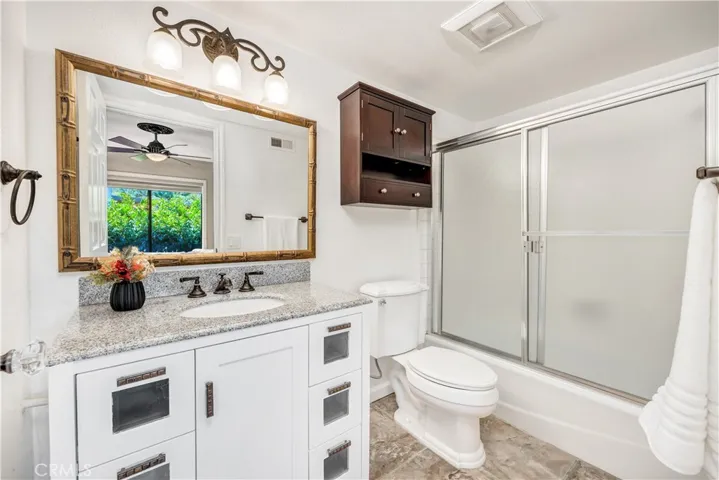The secondary bathroom with shower and tub combo.