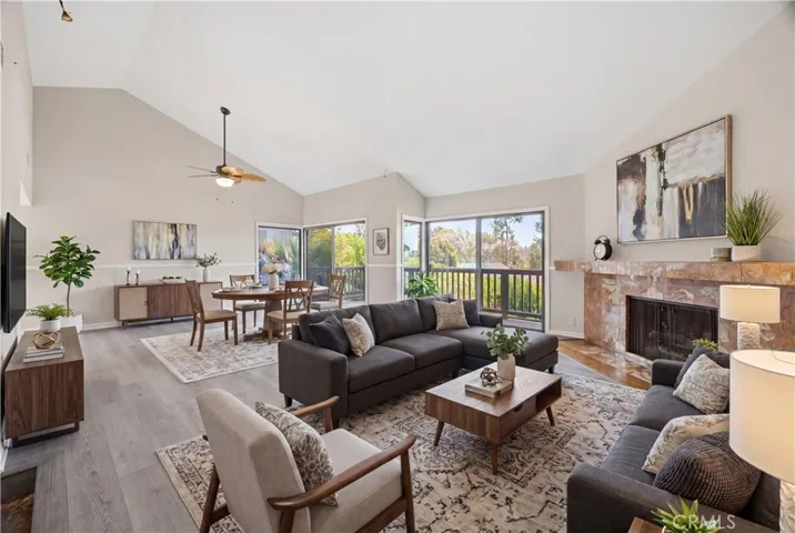 The light and bright living room and dining room with brand-new luxury floor, fresh paint and brand-new ceiling fan/light. Virtually staged.