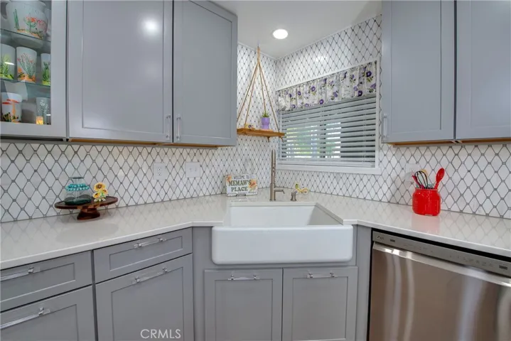 Farm sink surrounded by custom cabinets galore.