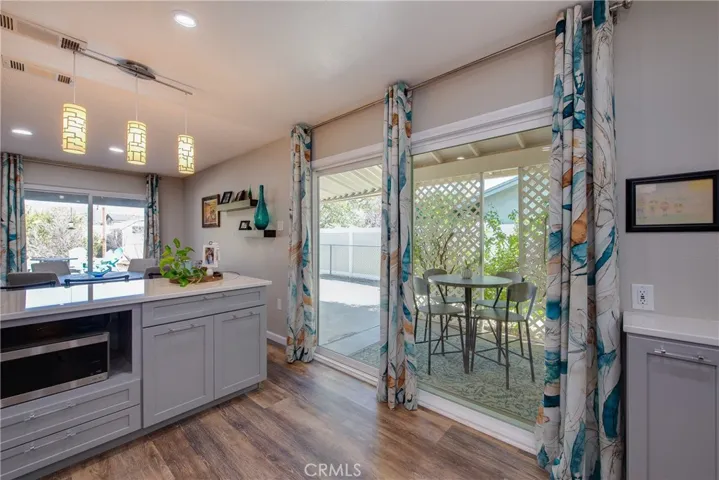 Dual pane sliding glass door from the kitchen to a covered side patio.