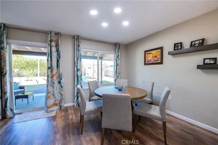 Dining room with recessed lighting overlooking the huge lush yard.