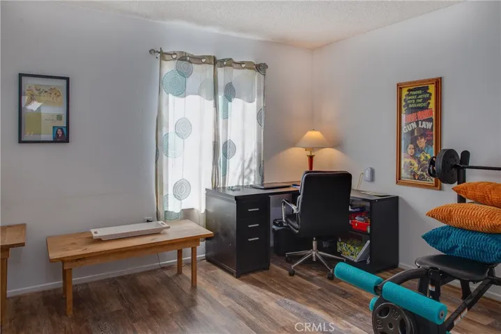 The front bedroom with wood type laminate floors is currently being used as as office without a closet.