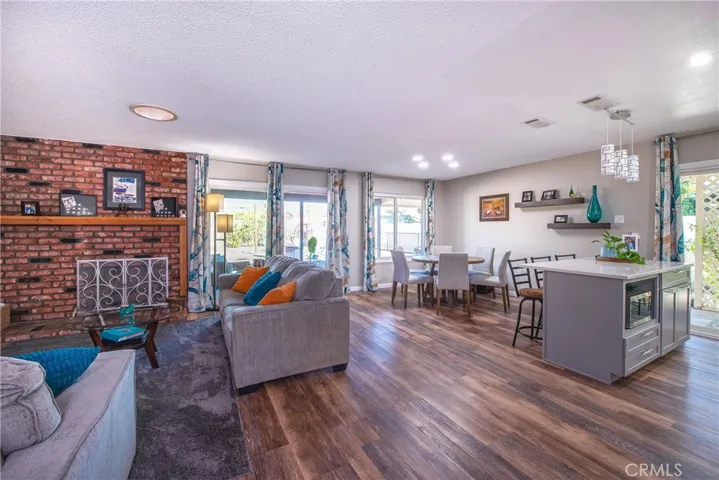 Living room, dining room and kitchen island. Beautiful wood type laminate floors.