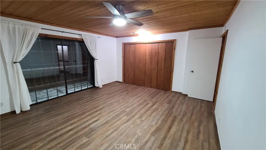 Unit B Master bedroom with sliding doors to upper deck.