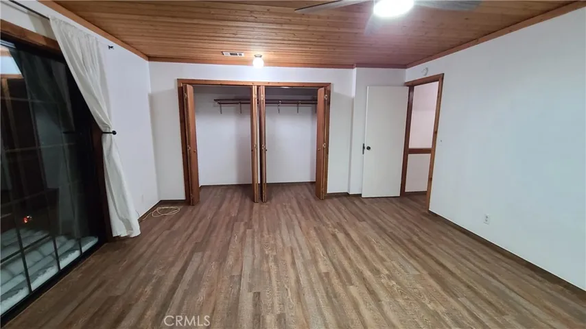 Unit B Master bedroom with sliding doors to upper deck.