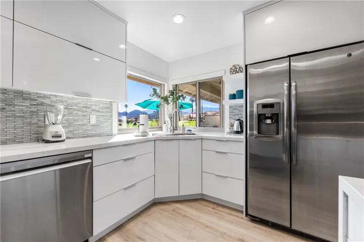 Corner kitchen sink enjoys sweeping views of the golf course, mountain vistas, and tranquil water features