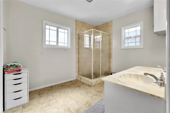 Primary Bathroom. Shower with glass doors, double sinks and walk in closet.