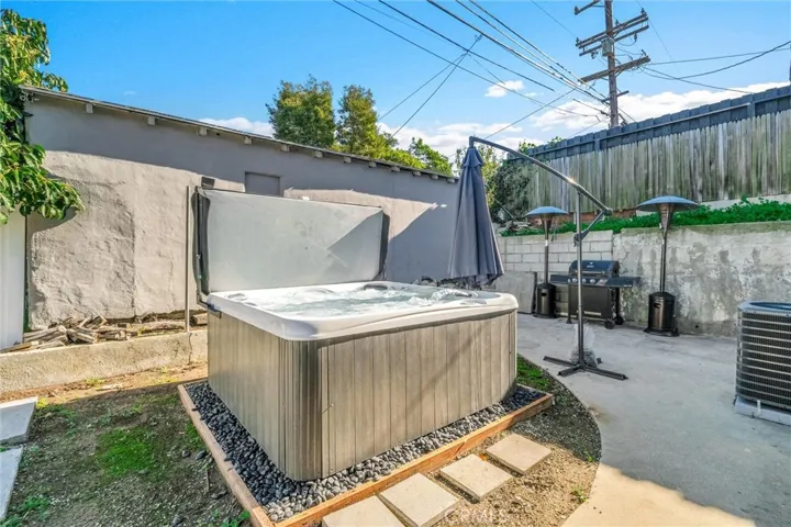 Relax in the backyard in this newer hot tub.