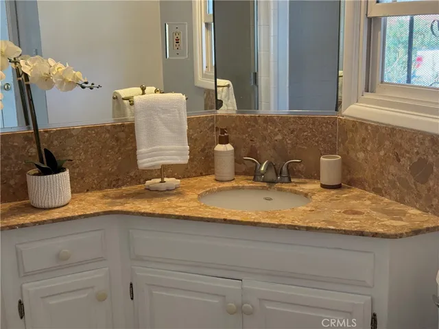 Bathroom in hallway with separate shower and tub.