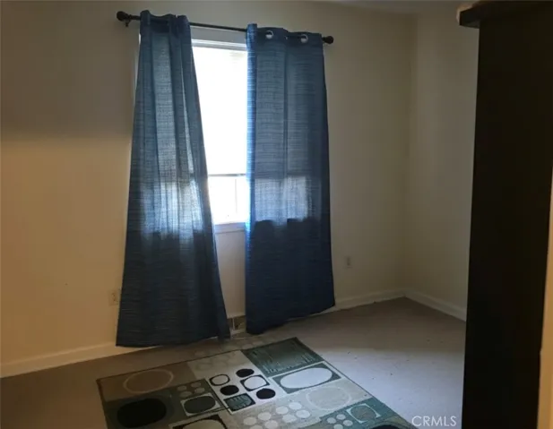 Back bedroom. Furniture digitally removed. Photos accurately represent the property's layout and features.