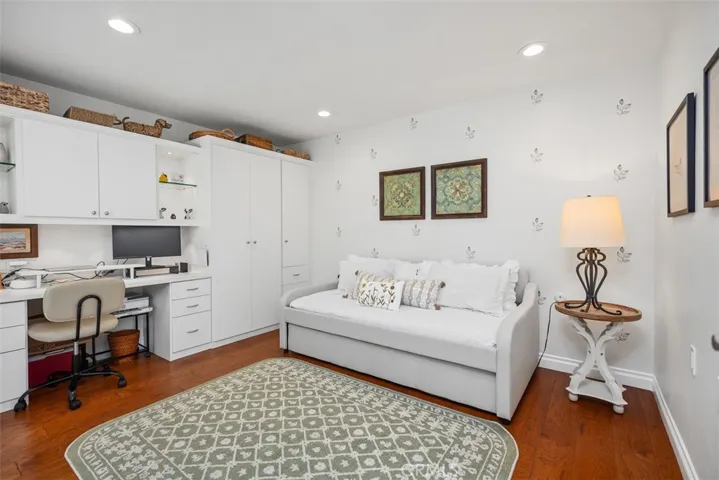 Guest room with built ins and recessed lighting