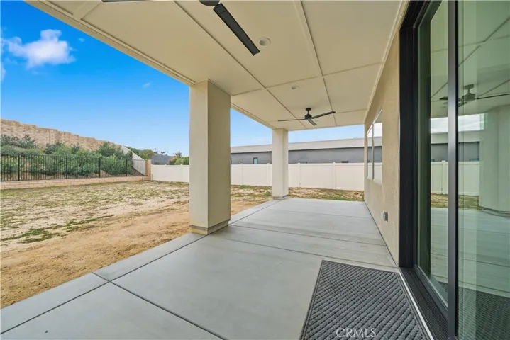 Covered back patio with two ceiling fans