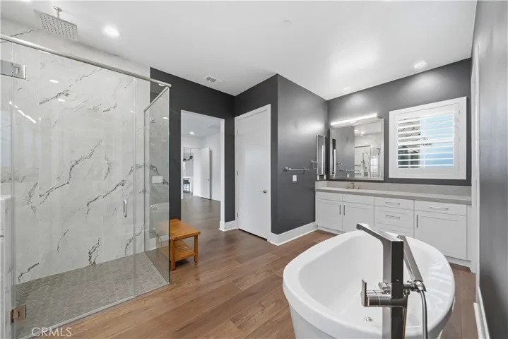 Primary en suite large walk in shower, deep soaker tub, two separate vanities