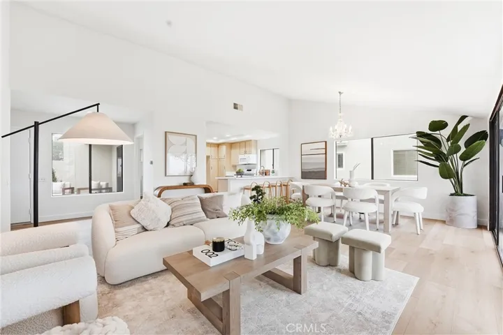 The spacious living room is bathed in natural light and anchored by a striking fireplace.