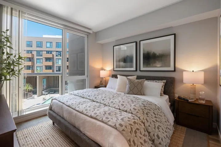 Bedroom featuring a wall of windows