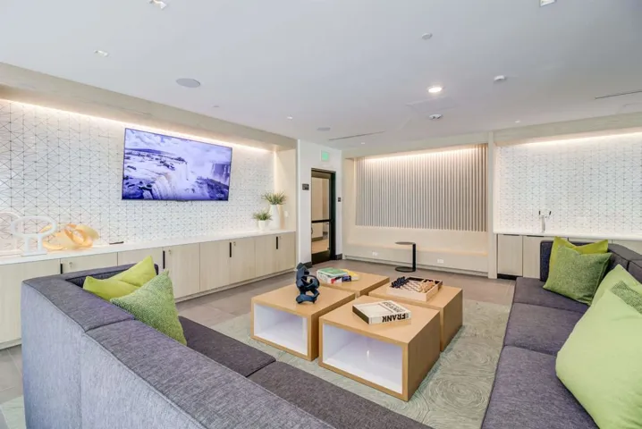 Living area with wallpapered walls, light tile patterned floors, and recessed lighting