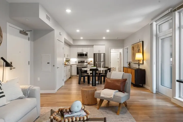 Living area featuring recessed lighting, light wood-style floors, and electric panel