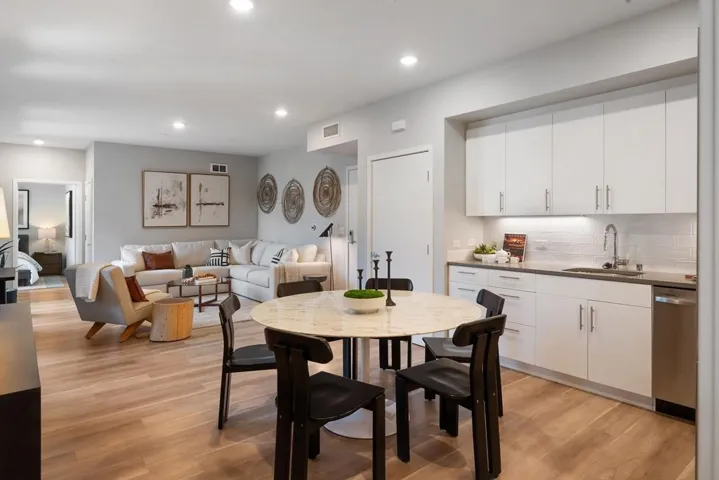 Dining room with light wood finished floors and recessed lighting
