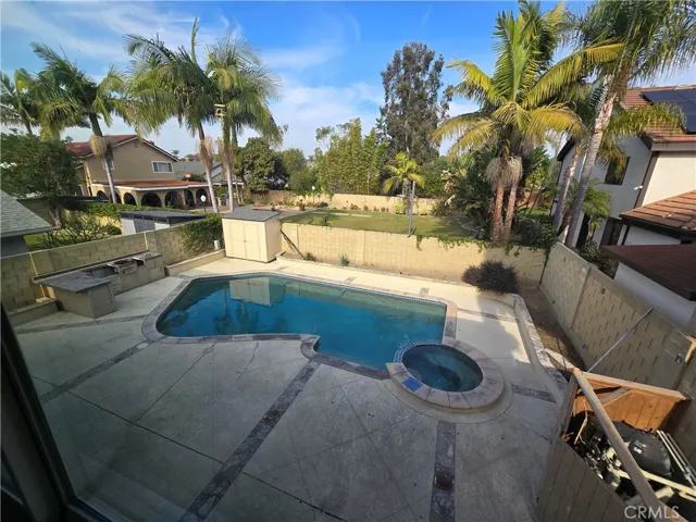 View from Primary room looking over backyard/pool.