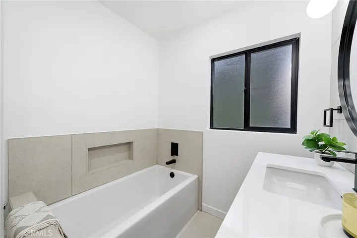 2229 Shoredale updated bathroom with a tub and separate shower to invite you to soak in.