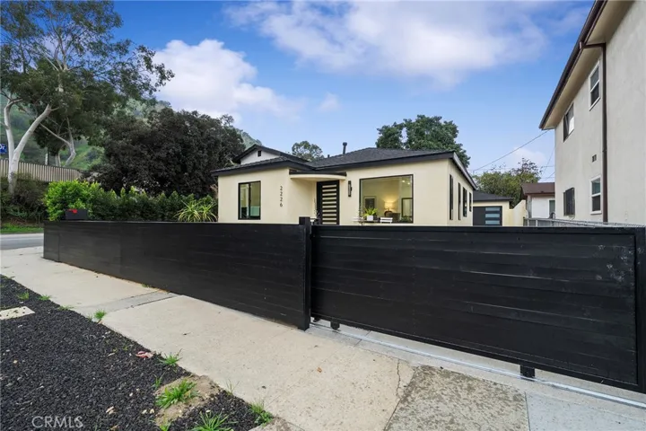 2229 Shoredale has a gated entry to the long driveway to the 2 car garage.
