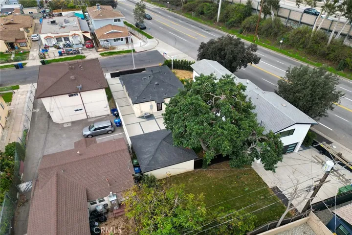 2229 Shoredale has the green yard and lush tree between both properties of 2225 and 2229 Shoredale.