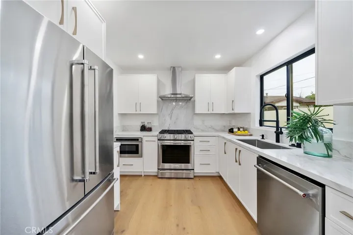 2229 Shoredale gorgeous kitchen with quartz counters and lovely hardware that adds to the elegance and comfort this home offers. Appliances included: Gas stove, refrigerator, dishwasher and drawer microwave.