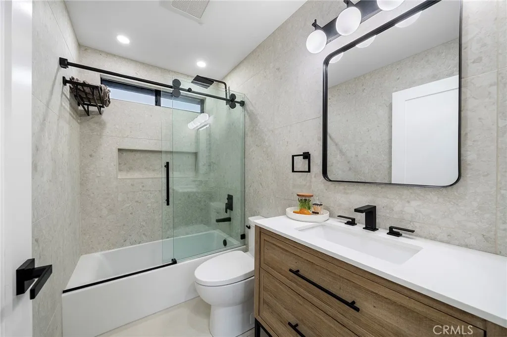 2225 Shoredale Beautifully updated bathroom that also features large built in shelf and towel shelf with a spa feel to get ready in.