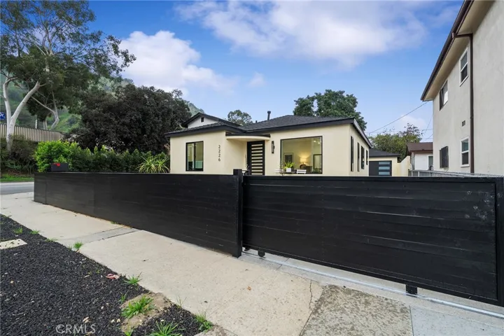 2229 Shoredale has a gated entry to the long driveway to the 2 car garage.