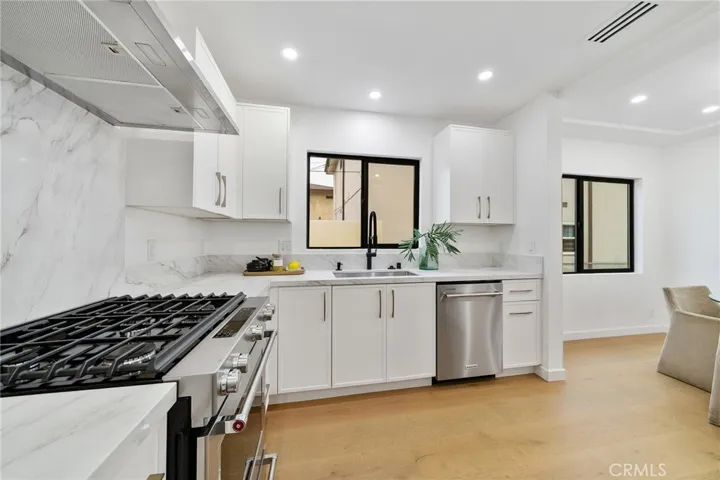 2229 Shoredale gorgeous kitchen with quartz counters and lovely hardware that adds to the elegance and comfort this home offers. Appliances included: Gas stove, refrigerator, drawer microwave and dishwasher.