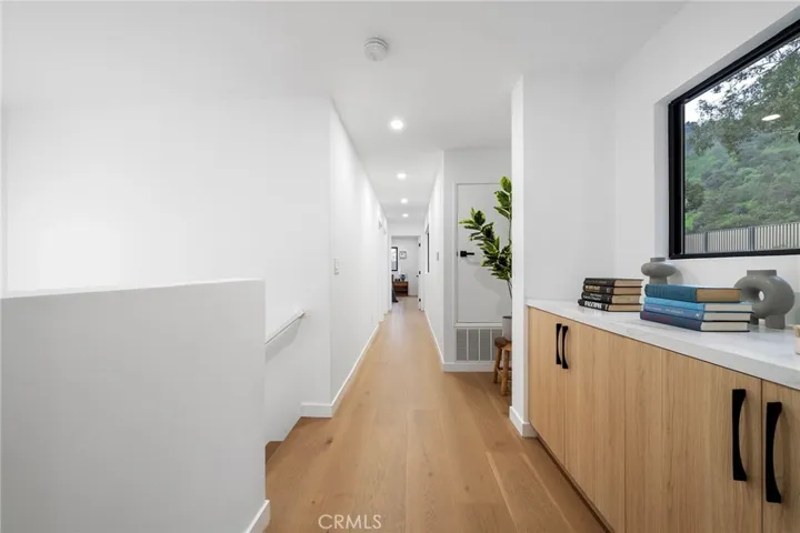 2225 Shoredale Top of the stairs has cabinets to place games, photos, linens, you decide. Right of landing to the primary bedroom with en suite and to the left to the two bedrooms and full bathroom.