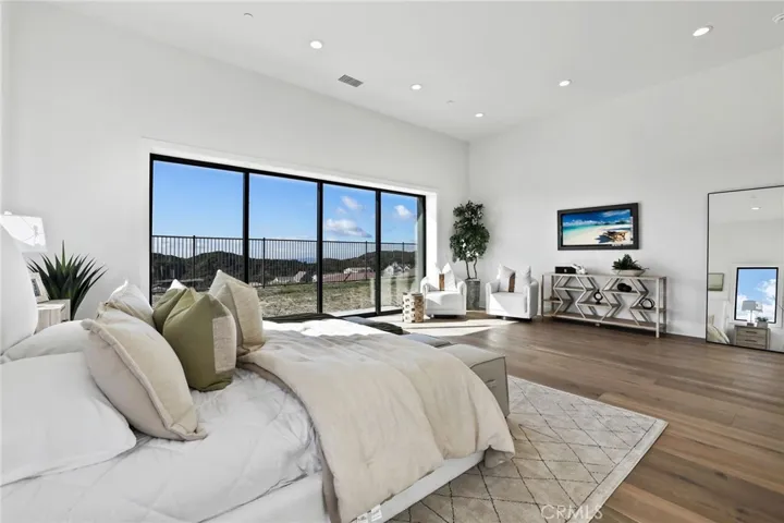 Huge Primary bedroom with doors to backyard and view