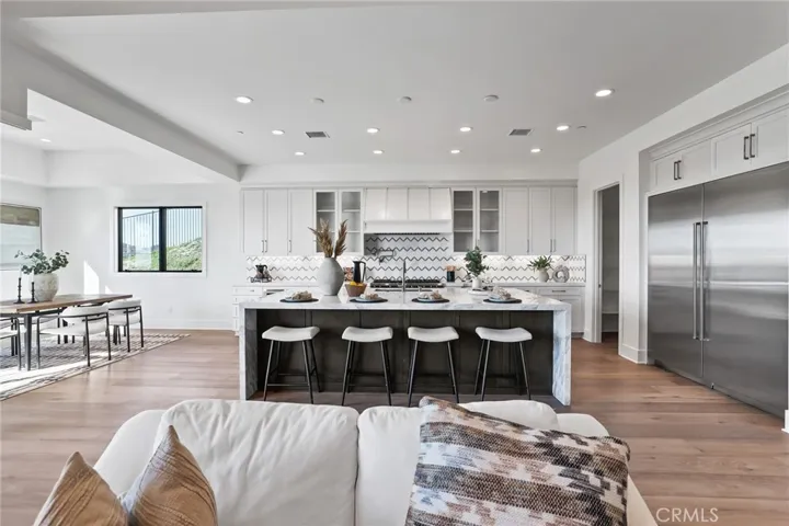 Gourmet kitchen with two tone cabinets, waterfall island