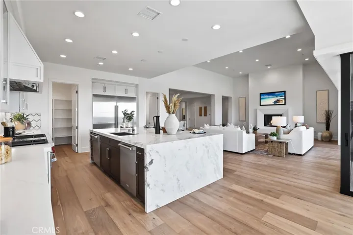 Gourmet kitchen with two tone cabinets, waterfall island