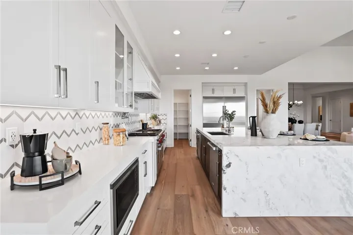 Gourmet kitchen with two tone cabinets, waterfall island