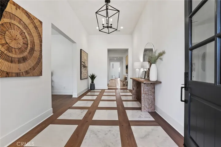 Entry with wood floors and inlaid marble
