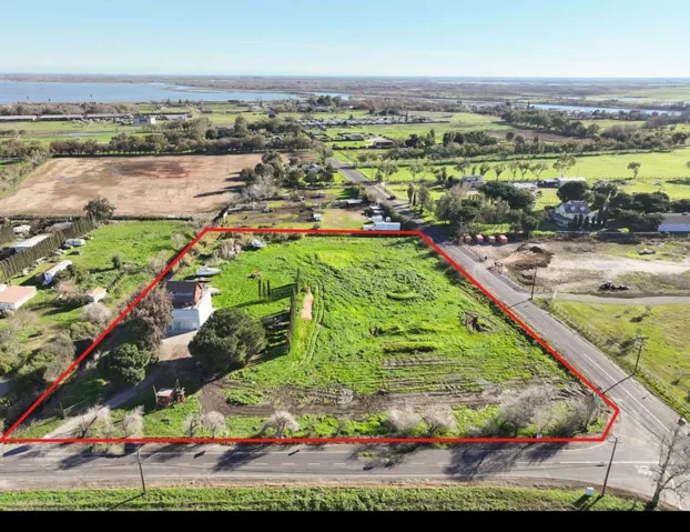 Overview of rural landscape with property boundaries highlighted and a large body of water