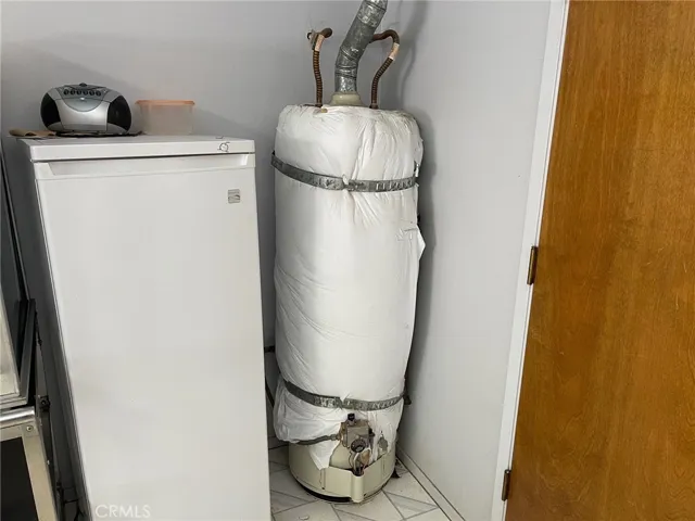 Water heater in institutional-style kitchen.