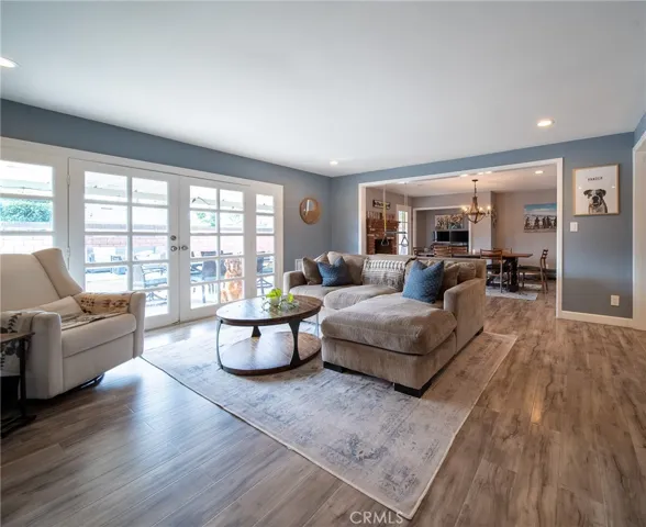 Open Living room with French doors leading to the backyard