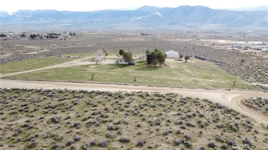 28.64 acres - 2,280 sq ft home - 2,400 sq ft airplane hangar/shop - Private well  - Hwy 18 frontage - Western Lucerne Valley