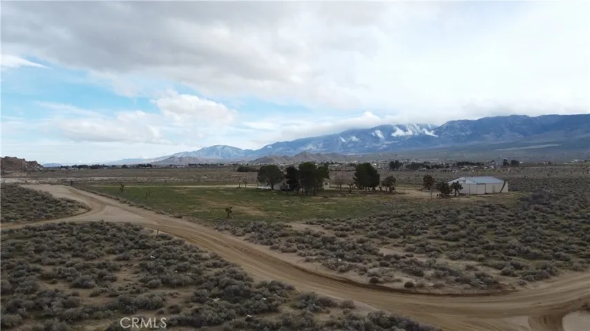 28.64 acres - 2,280 sq ft home - 2,400 sq ft airplane hangar/shop - Private well  - Hwy 18 frontage - Western Lucerne Valley