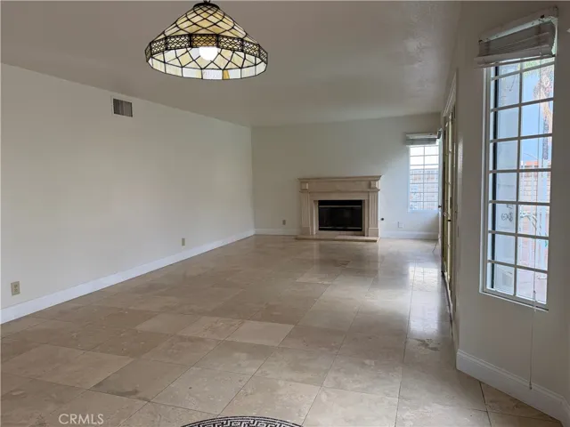 Dining area open up to living room with fireplace