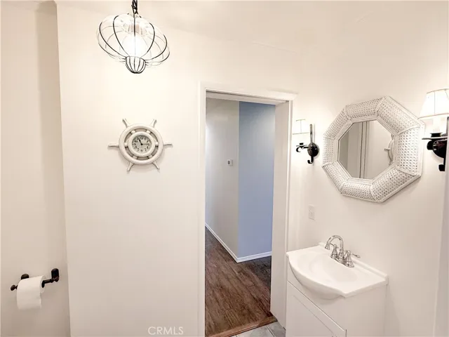 half bath off hallway and kitchen, includes stackable laundry