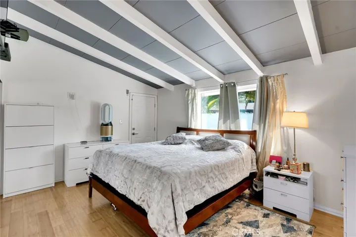 Primary bedroom pic1 with beamed ceiling