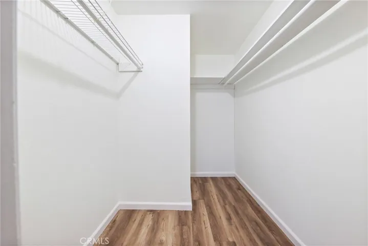 Spacious walk in closet in primary bedroom