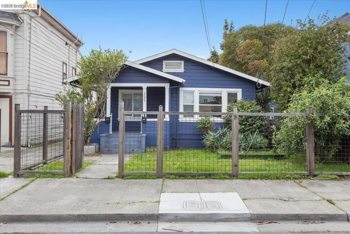 View of front of home featuring a fenced front yard, a gate, and covered porch