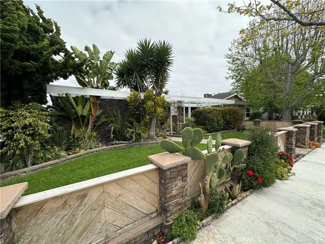 Inviting street presence highlighted by mature landscaping and a thoughtfully maintained front lawn.
