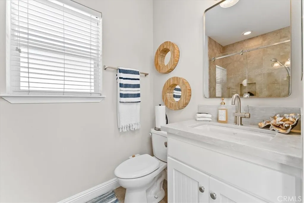 Upgraded Bathroom with New Quartz Counter, Faucet, Vanity Mirror, and Big Shower