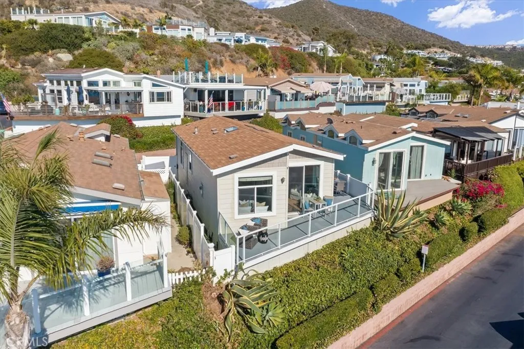 Side Yard to the North is a Fully-fenced Turf Dog Run with Surfboard Racks